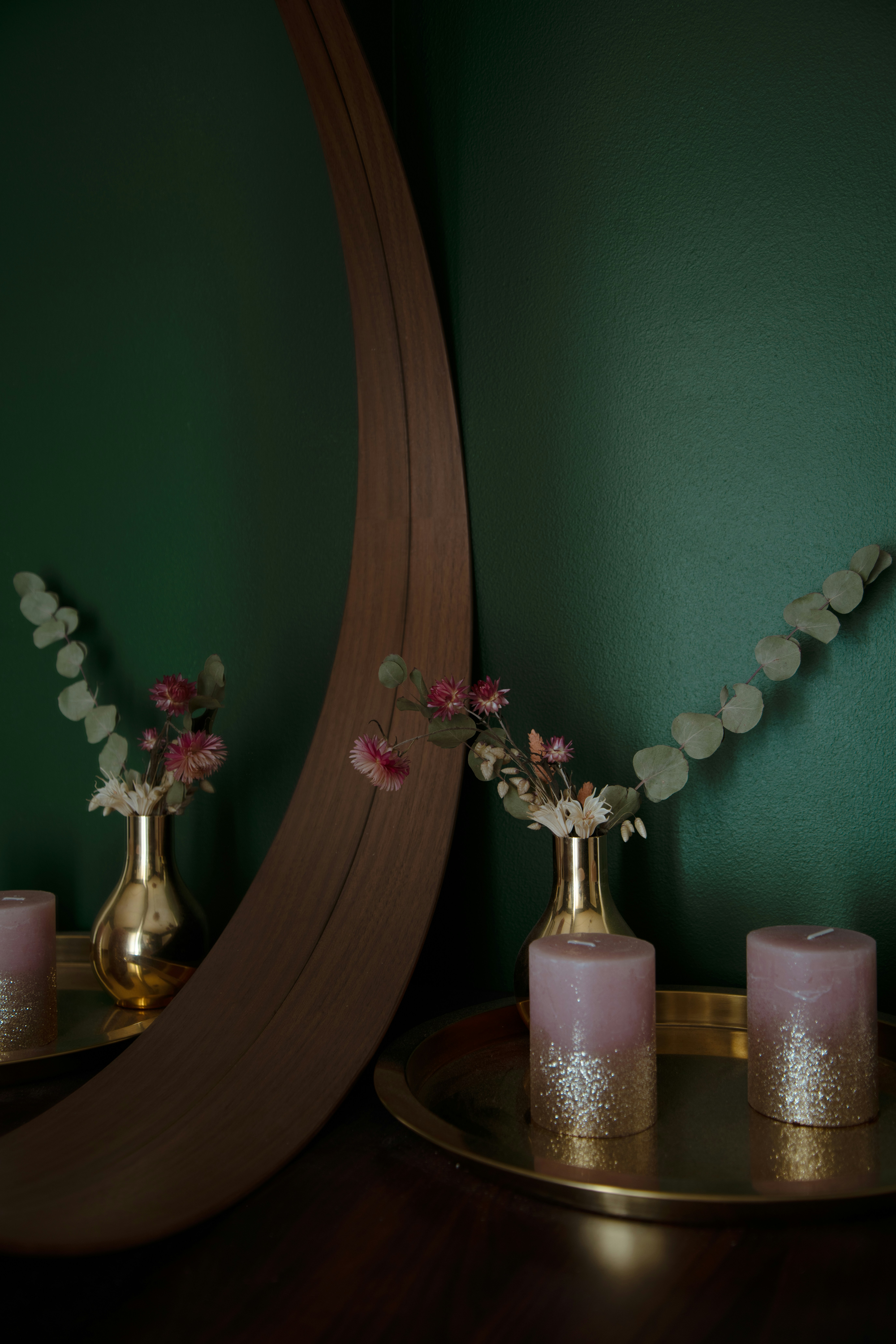pink and white moth orchids in clear glass vase on brown wooden table