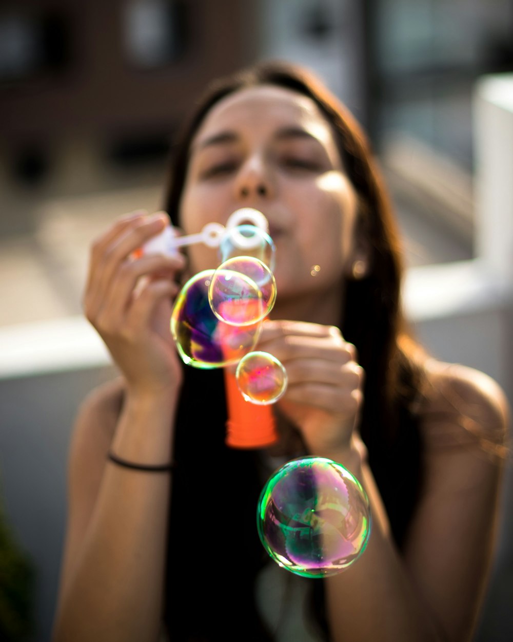 woman blowing bubbles during daytime