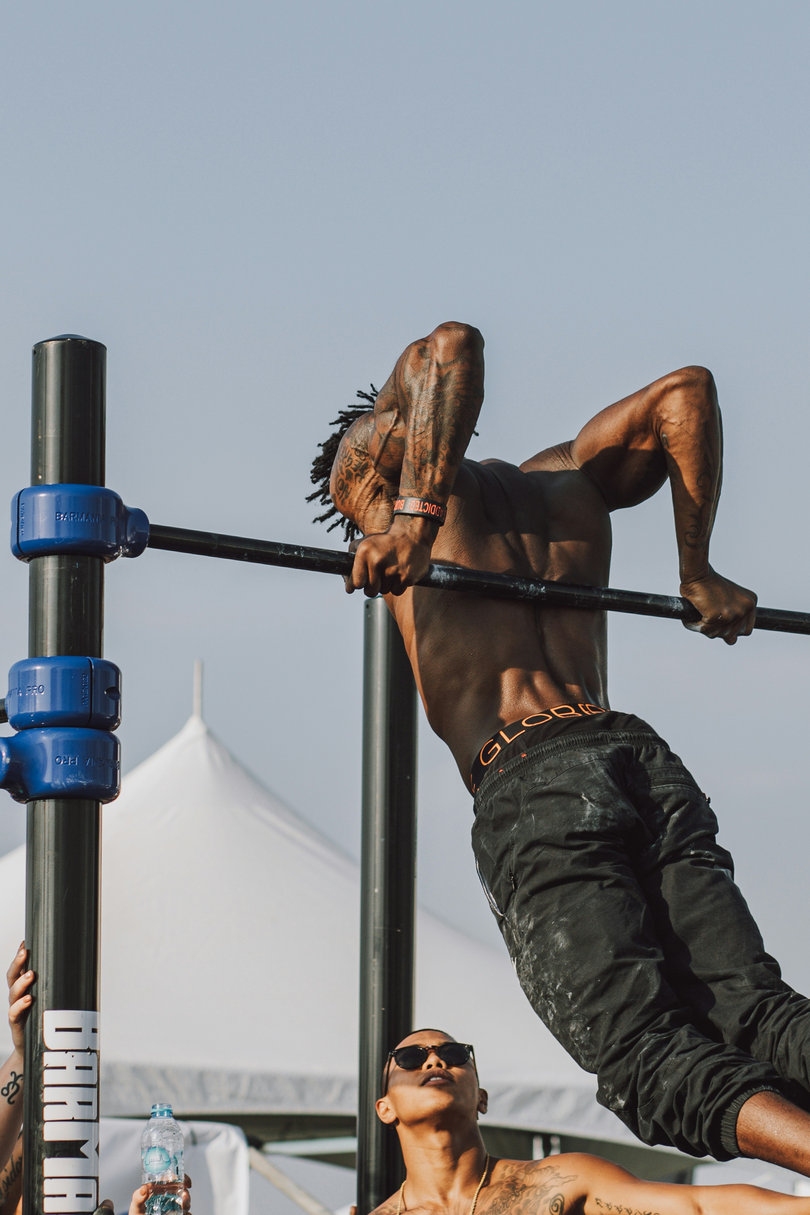 man in black pants climbing on brown wooden ladder during daytime