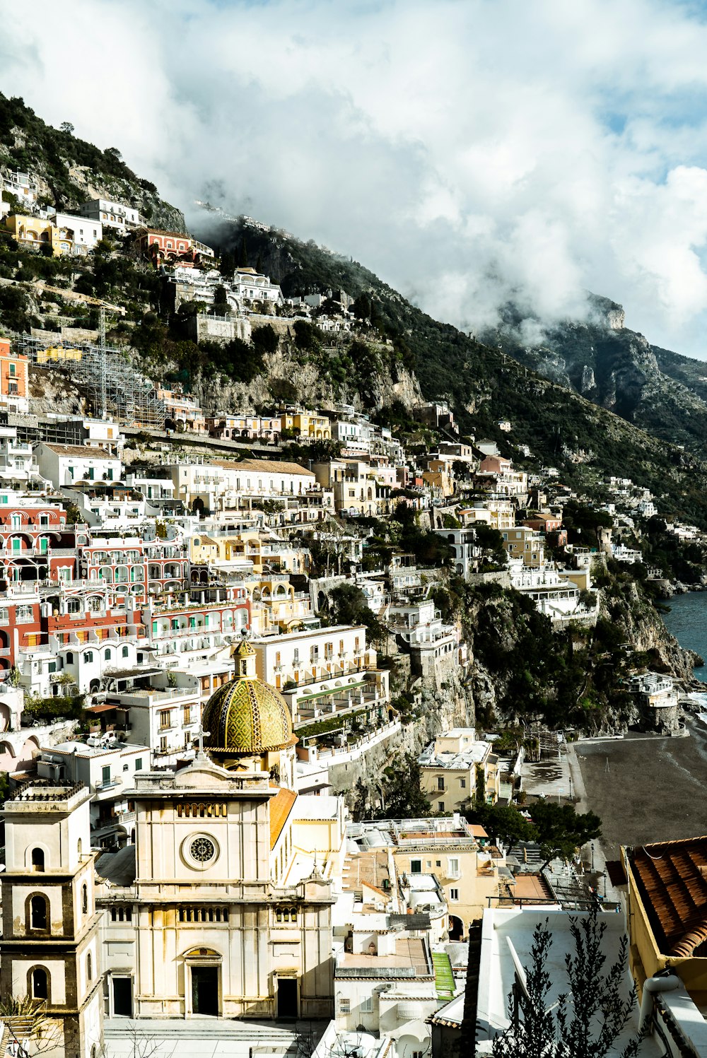 white and brown concrete buildings near mountain during daytime