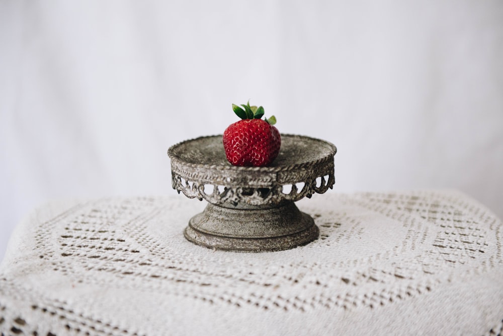 red strawberry on silver round tray