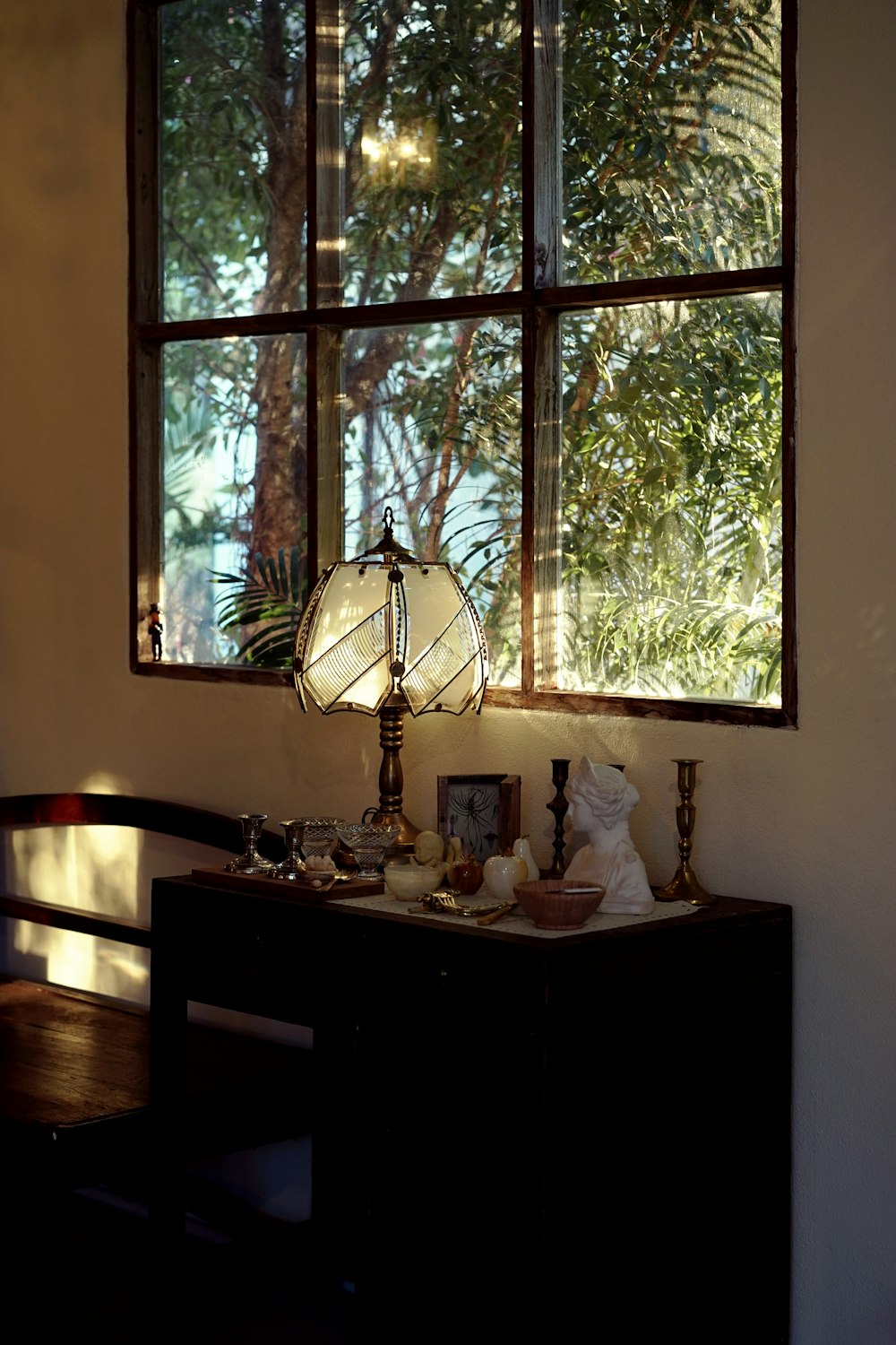 brown wooden desk with white table lamp on top