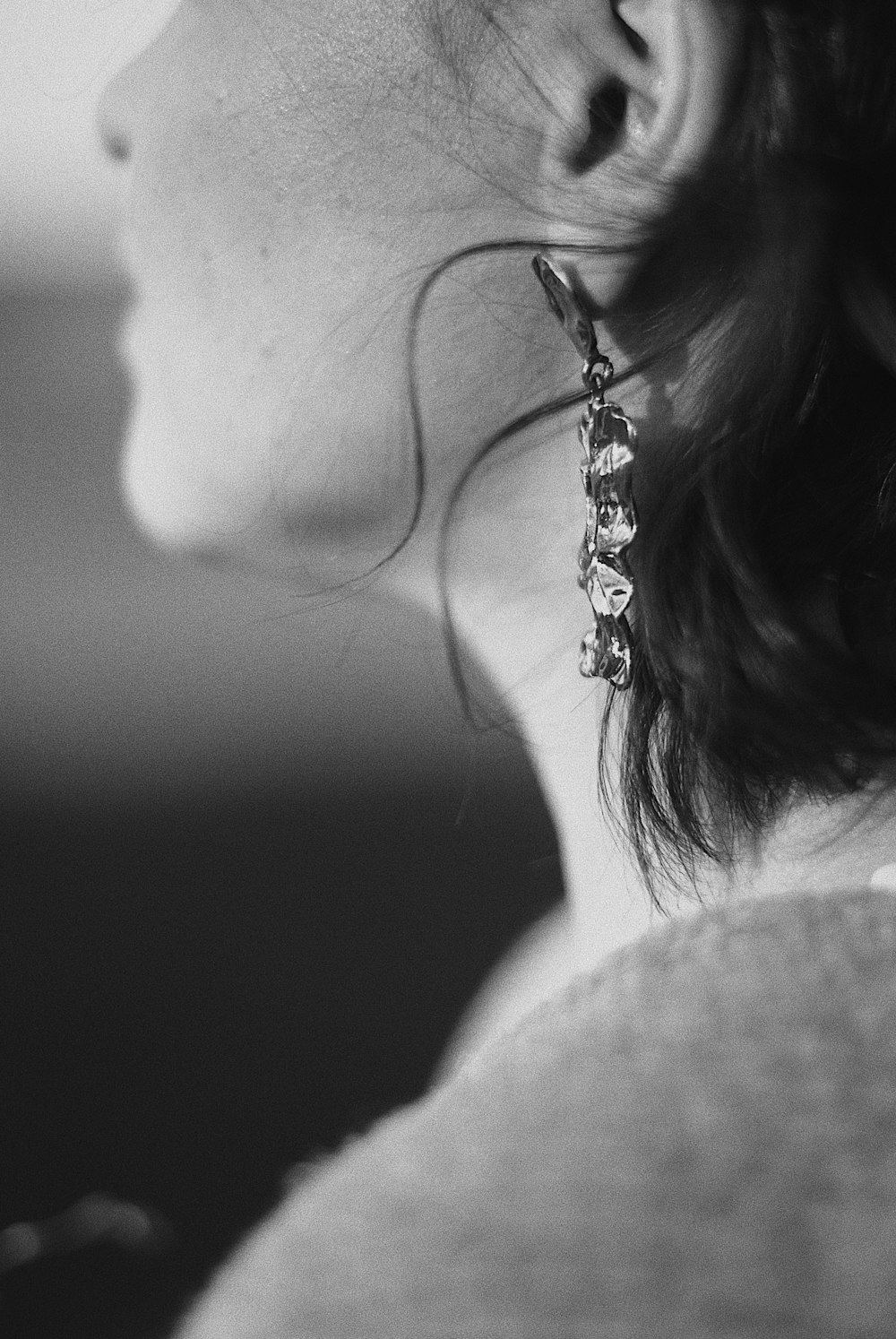 grayscale photo of woman wearing silver necklace