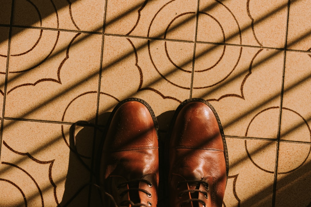 brown leather shoes on brown textile