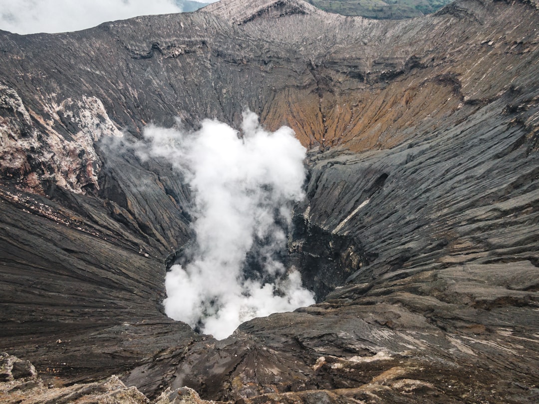 brown and gray mountain with white smoke