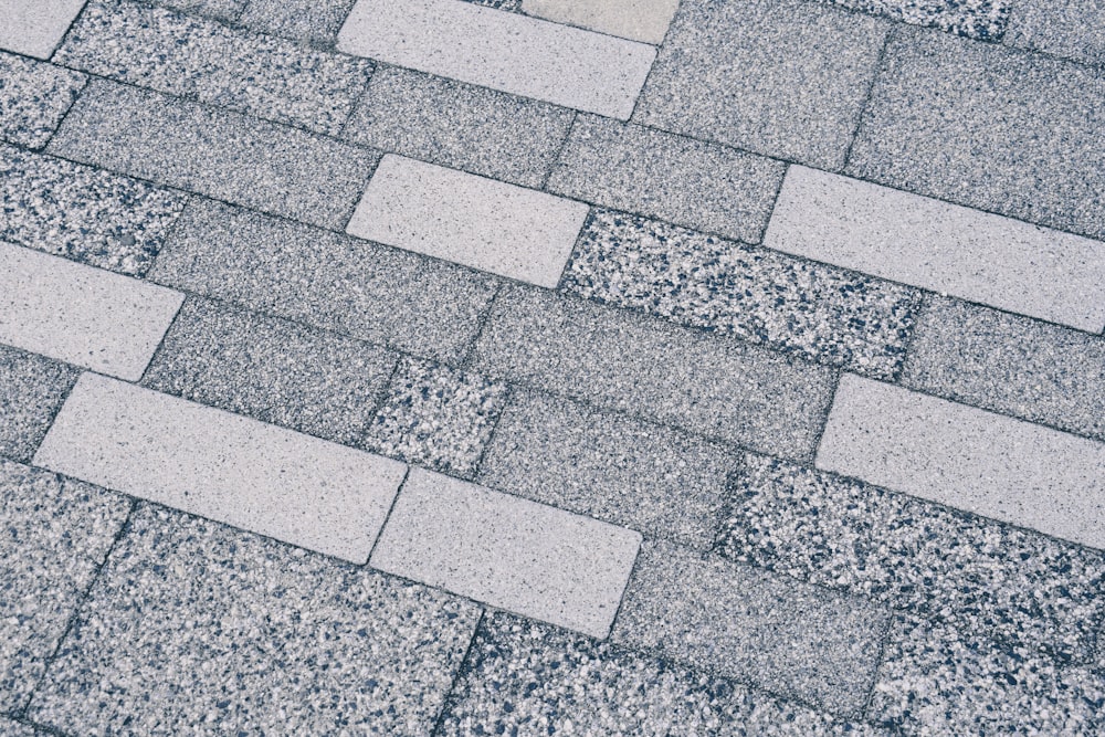 a close up of a sidewalk made of concrete blocks