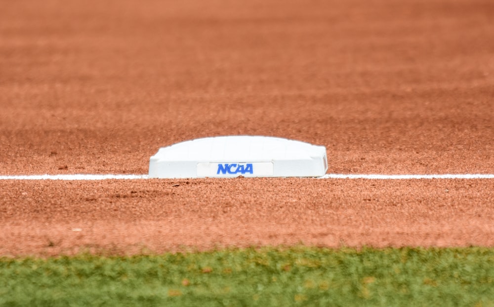 white and blue football helmet on green grass field during daytime