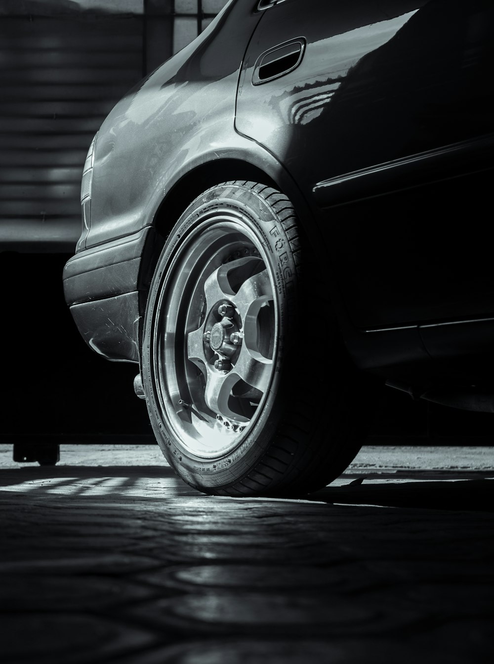 grayscale photo of car wheel