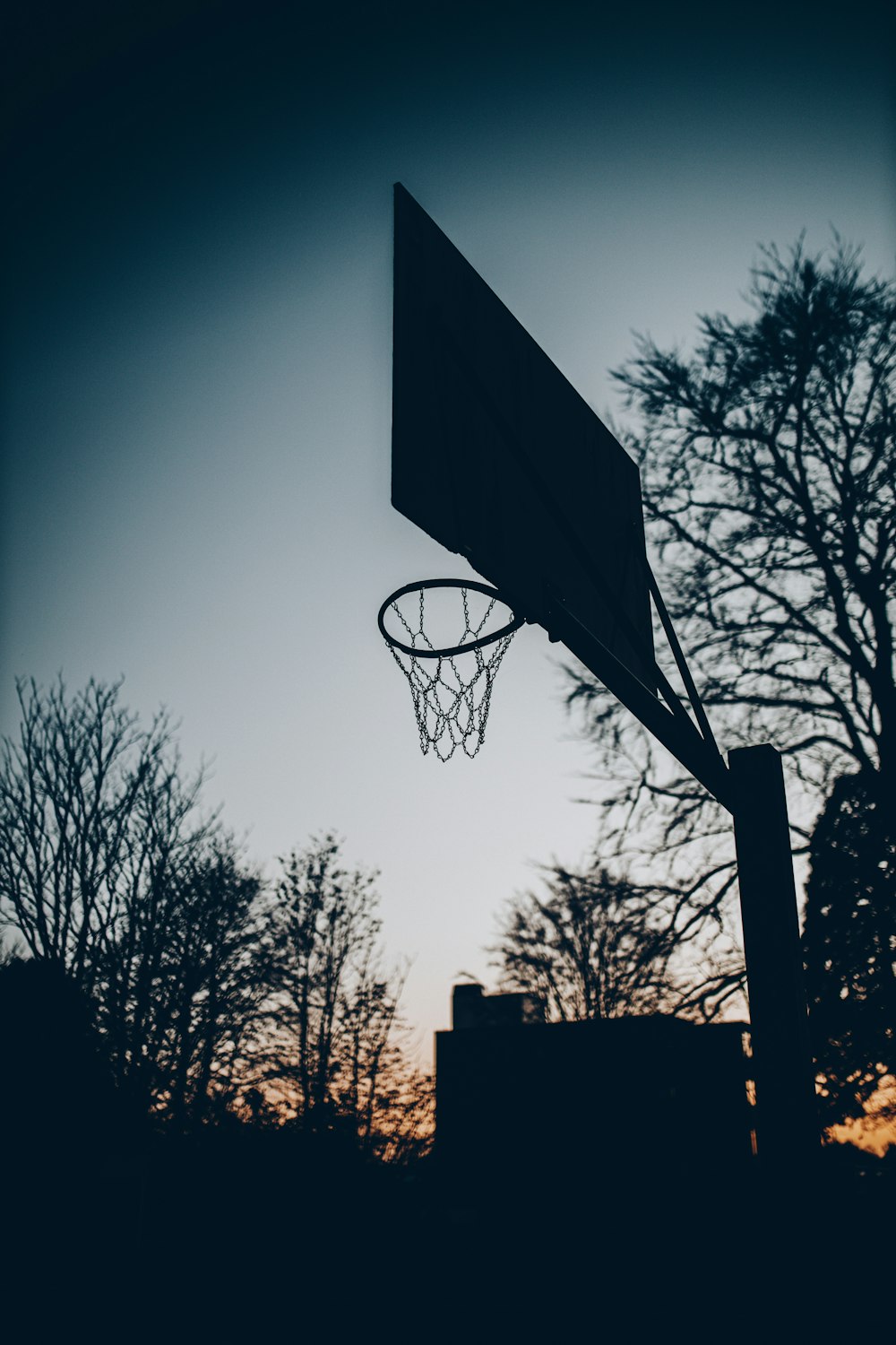 silhouette of basketball hoop during night time