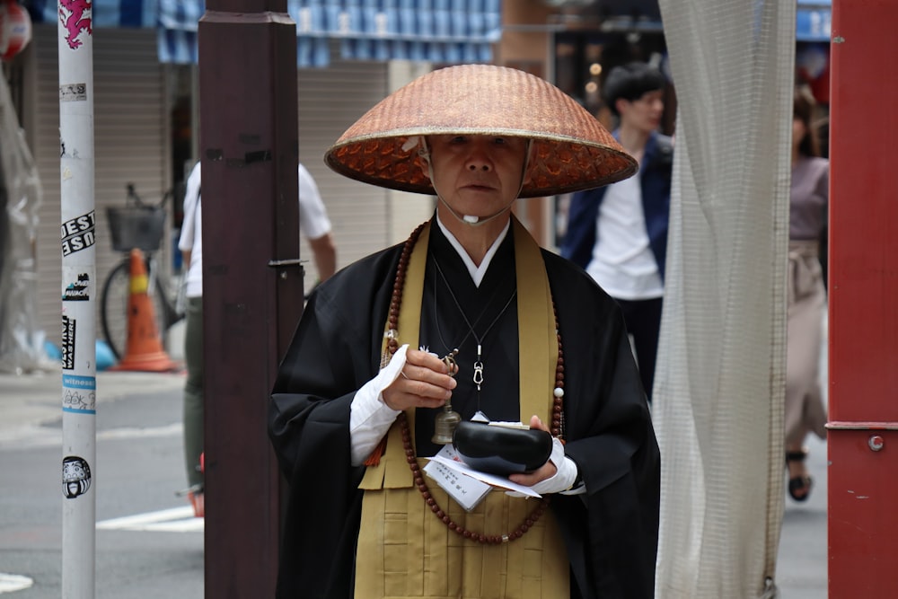 person wearing brown woven hat and black coat