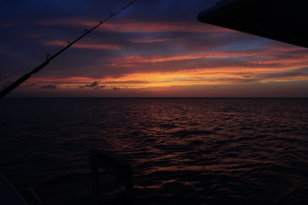 A sunset casting coral hues over a quiet fishing village on the island of Martinique.
