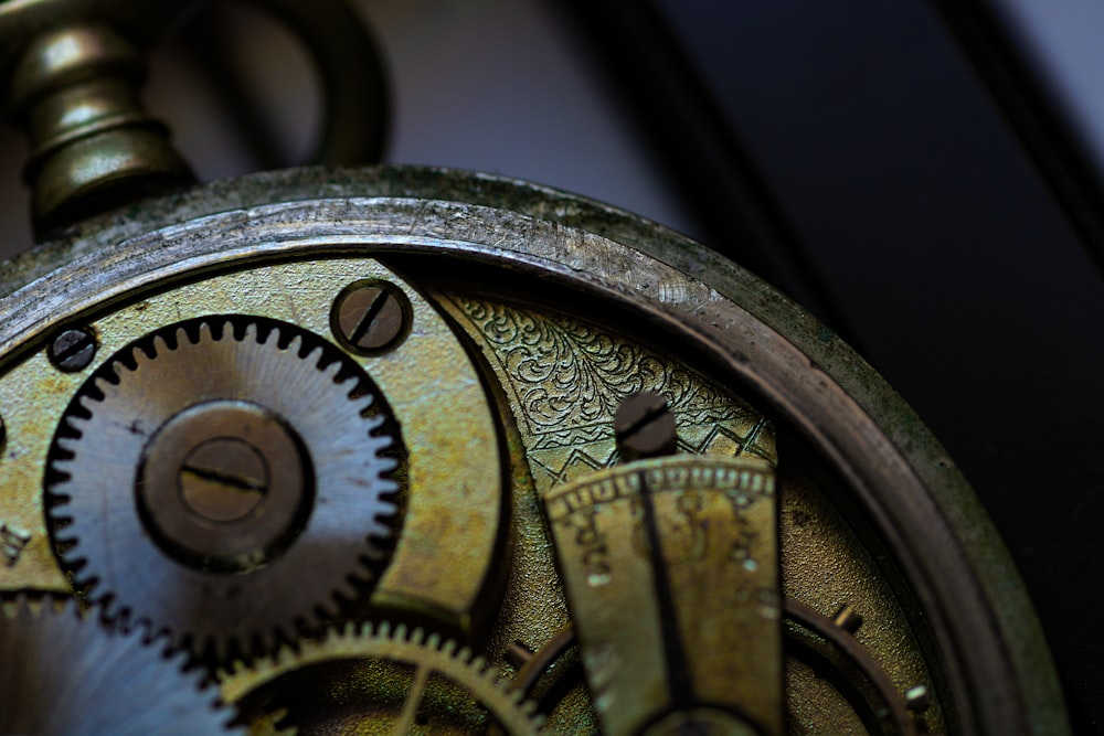 brass and black round analog clock