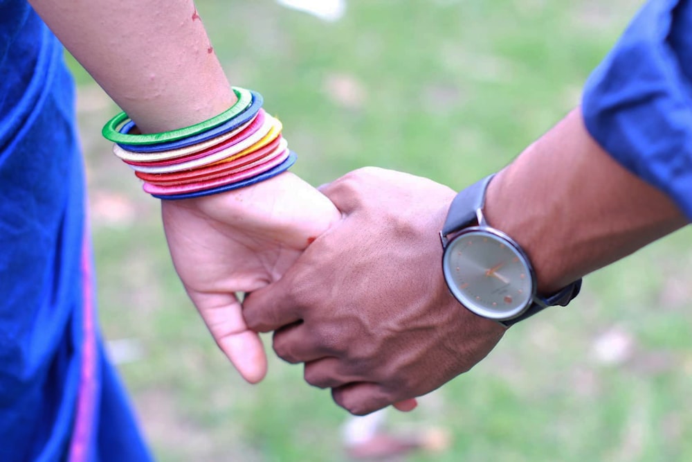 person wearing silver round analog watch