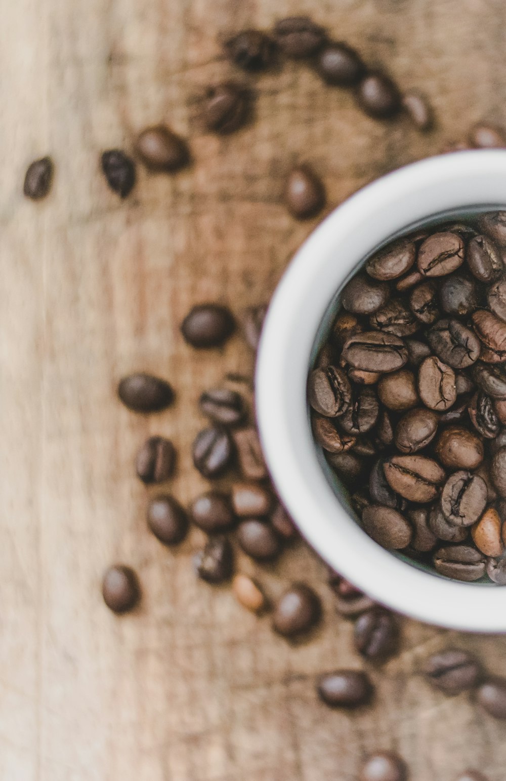 coffee beans in white ceramic mug