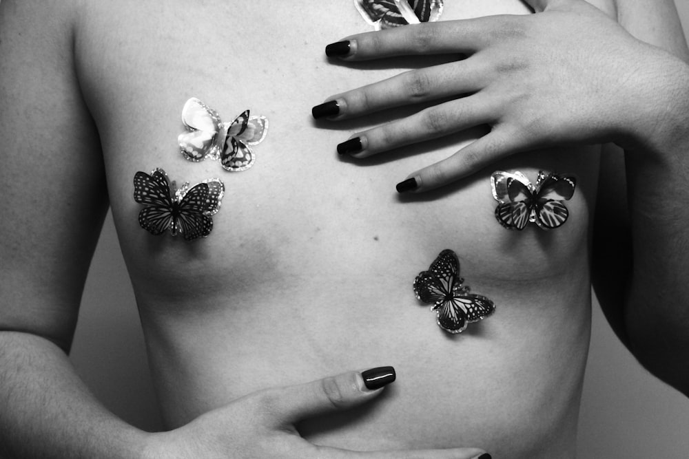 black and white butterfly on persons hand