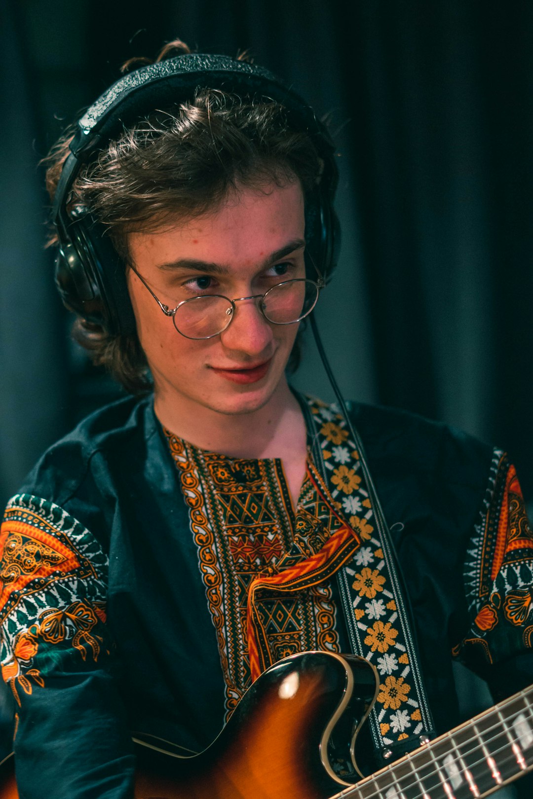 woman in blue and gold floral shirt wearing eyeglasses