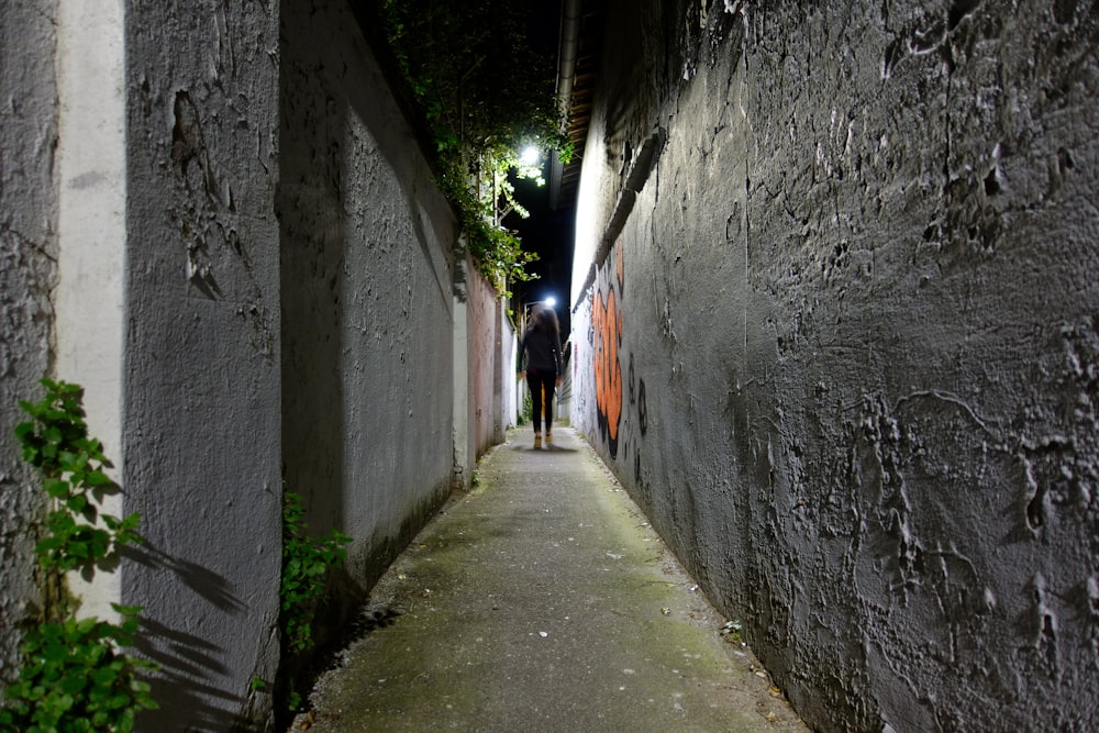 gray concrete pathway between gray concrete wall