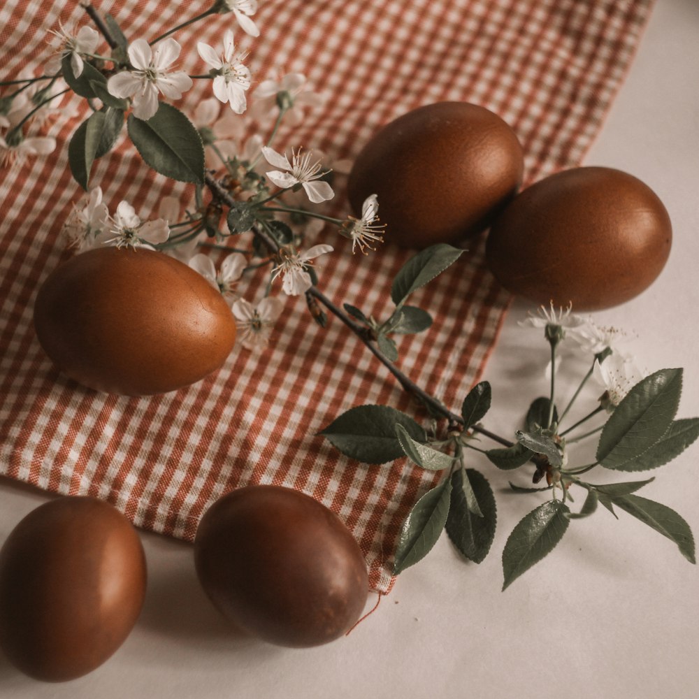 three orange fruits on white and brown checkered textile