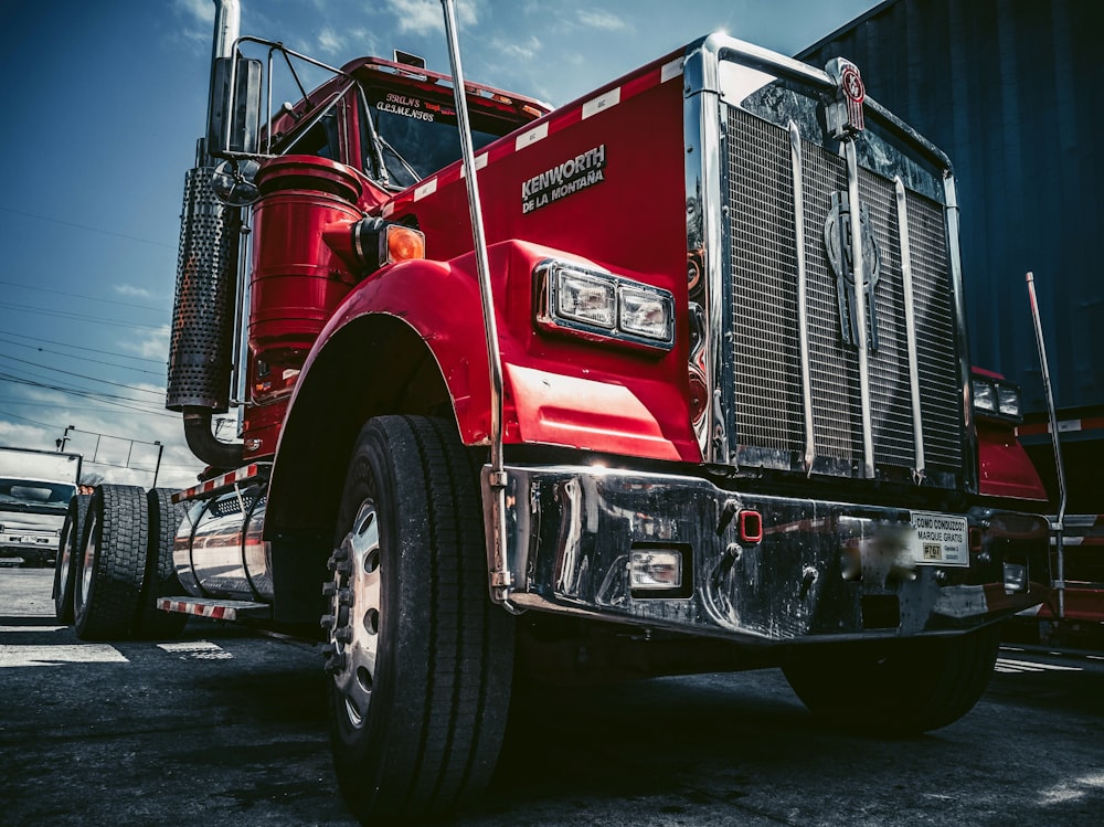 red and white truck on black asphalt road