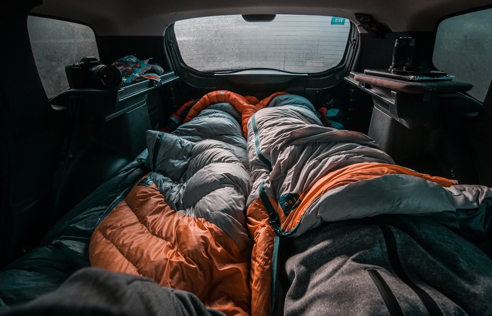 black and orange backpack on car seat