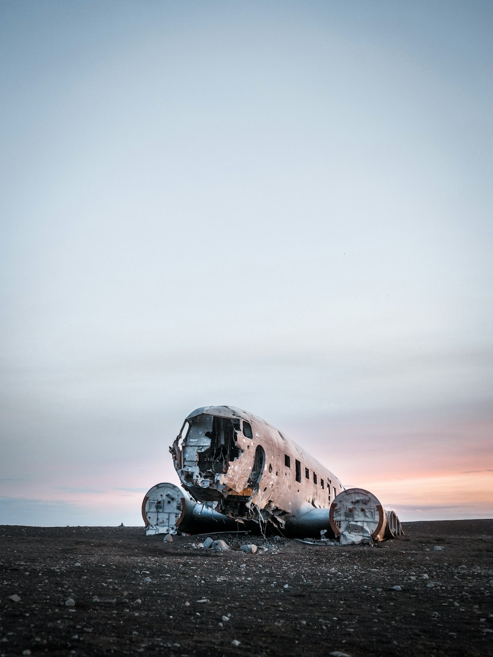 white and black airplane on gray sand during daytime