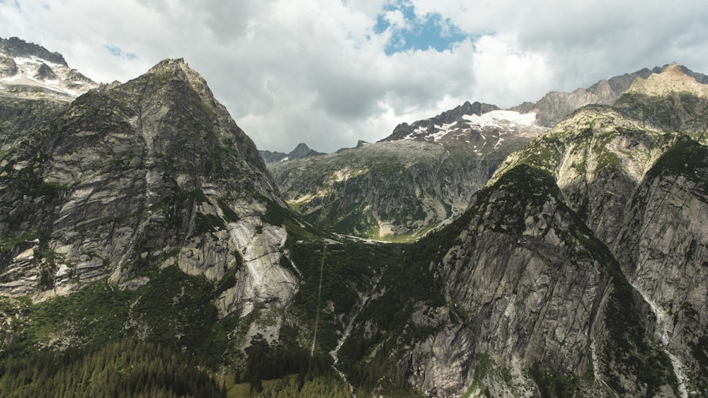 green and gray mountain under white clouds during daytime