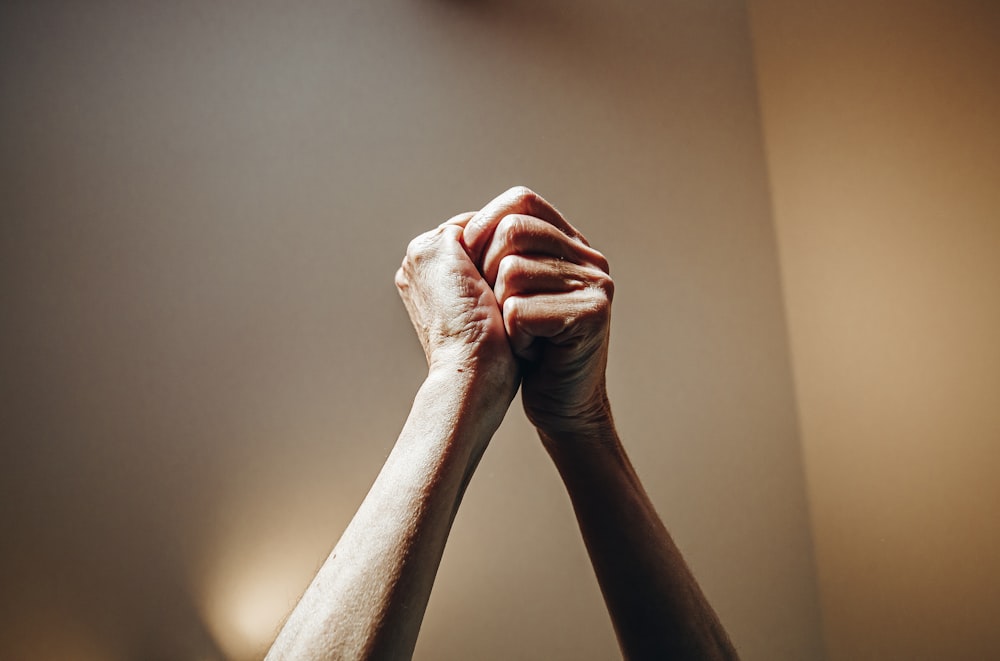 persons hand on white wall