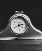 black and white analog alarm clock