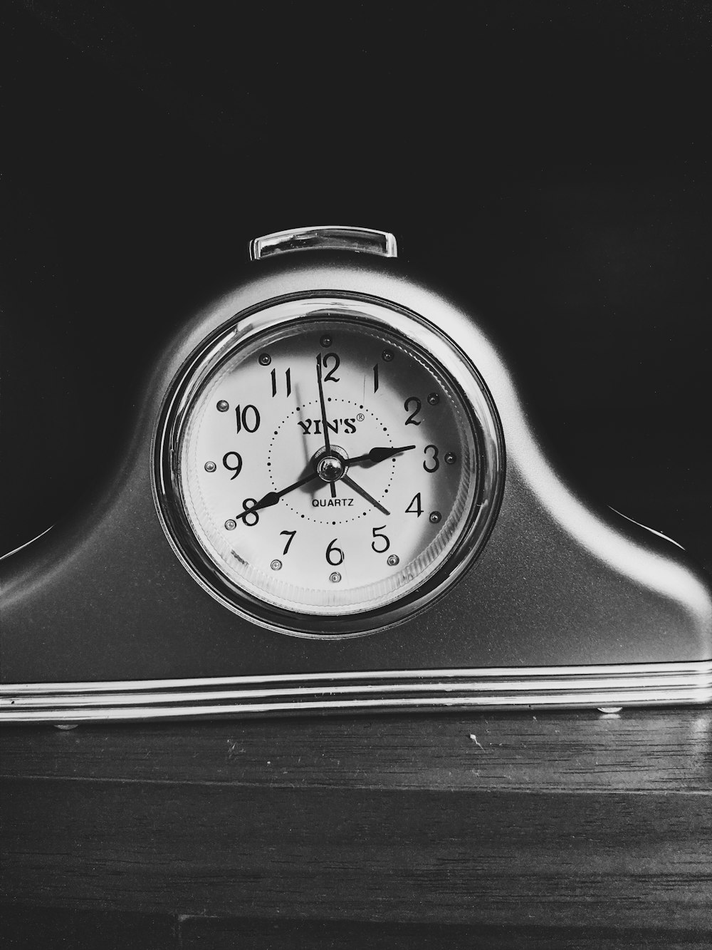 black and white analog alarm clock
