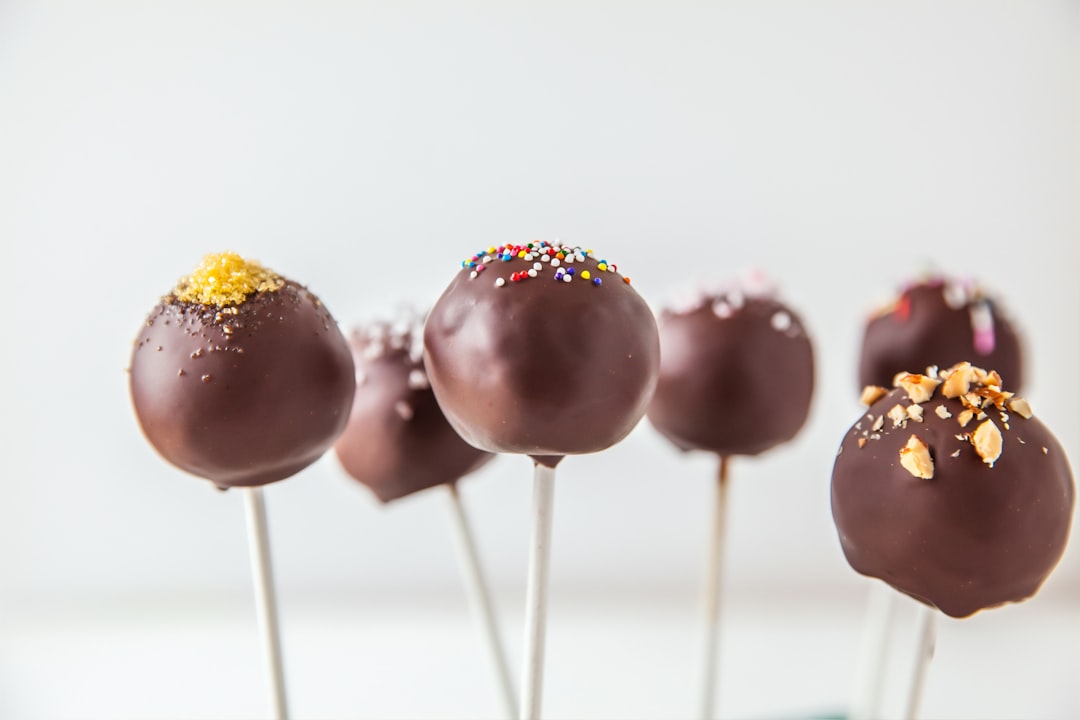 red and yellow lollipop on white surface,