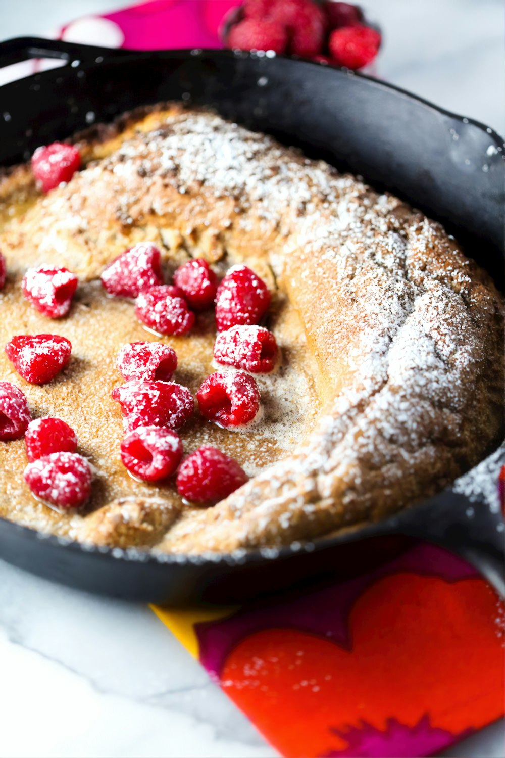 brown pastry with red and white berries on top