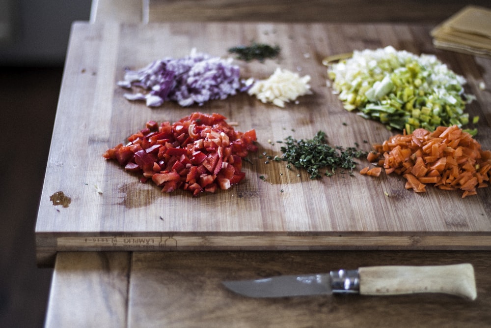 sliced vegetables on brown wooden chopping board