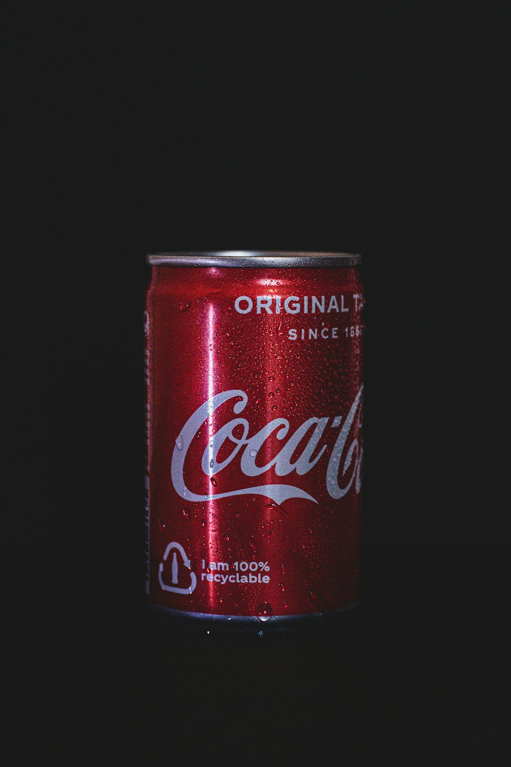 coca cola can on black surface