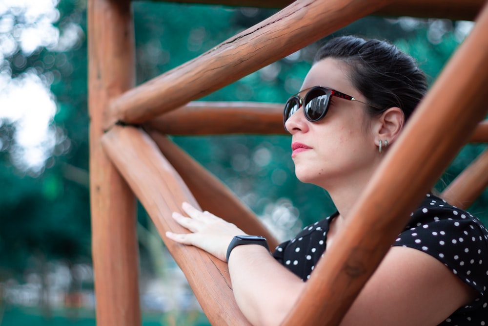 woman in black and white polka dot shirt wearing black sunglasses