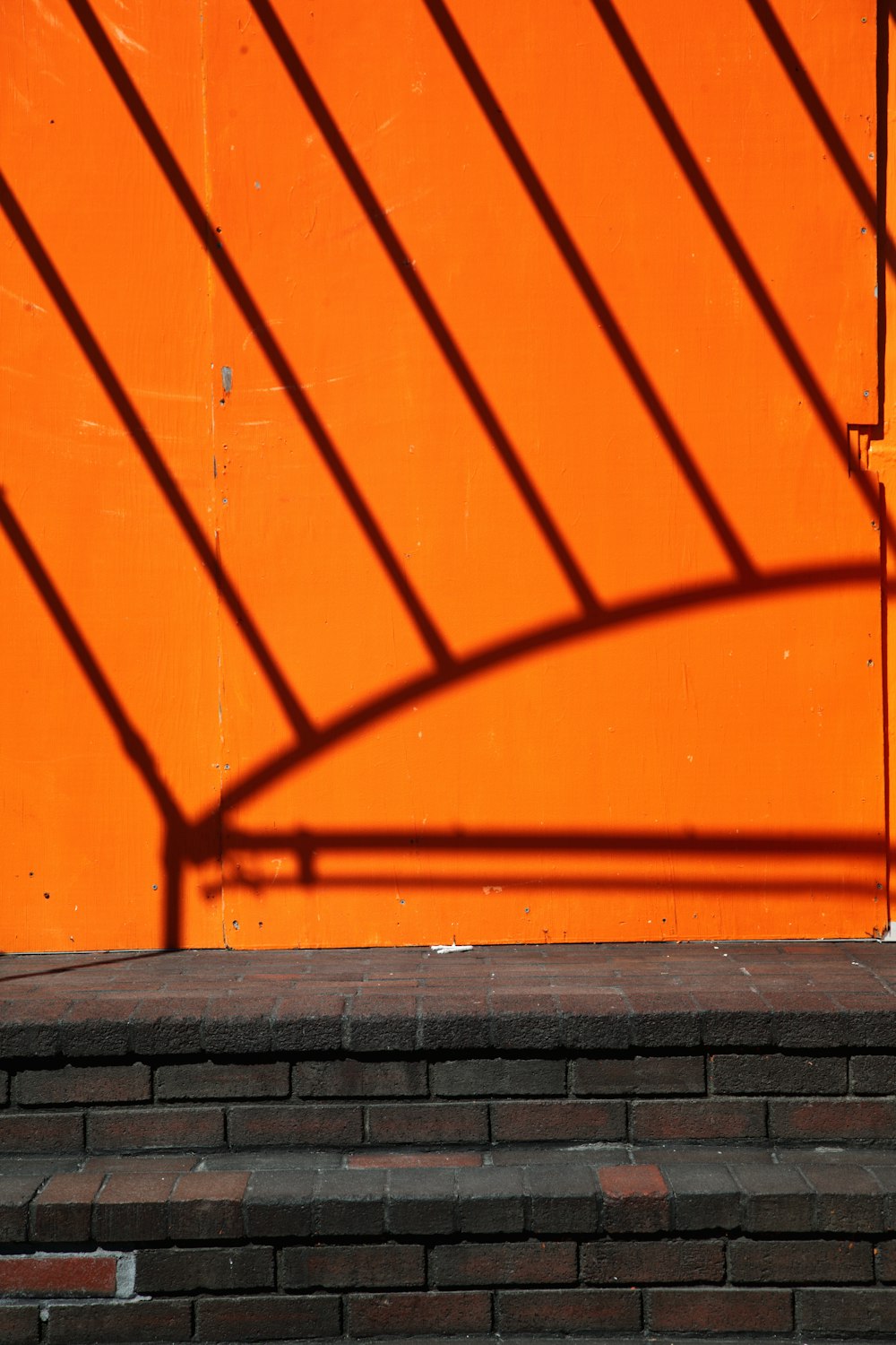 orange wall with shadow of a person