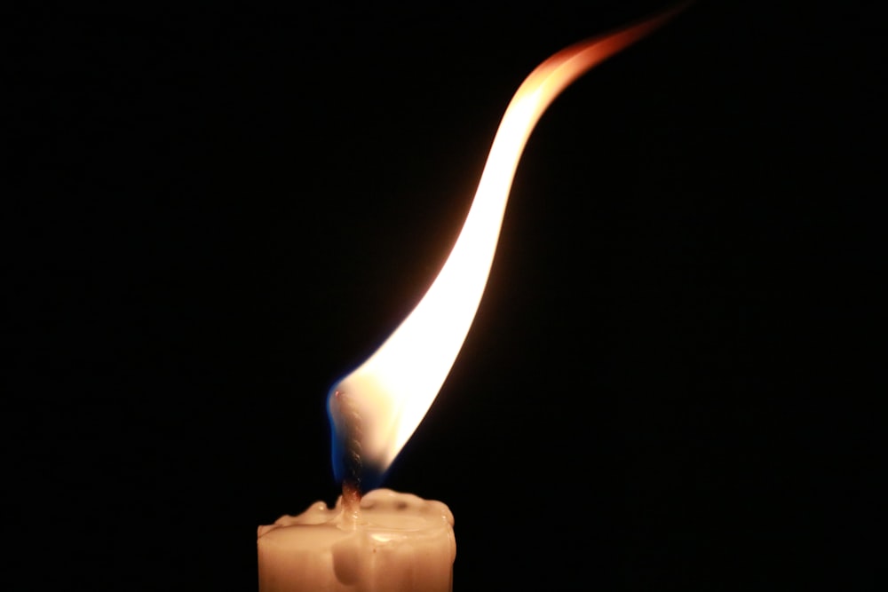 white candle in black background