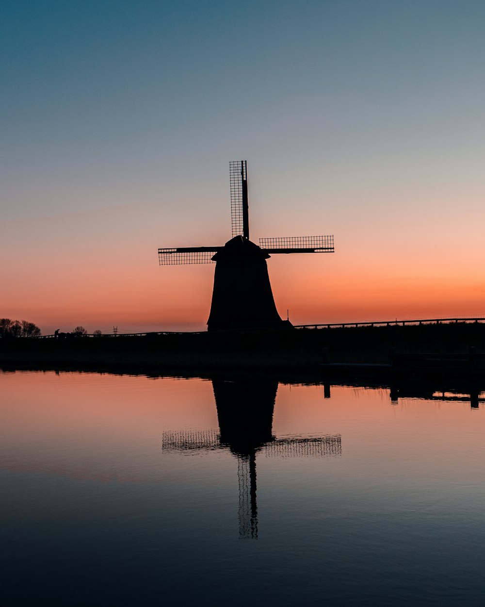 silhouette of airplane on water during sunset