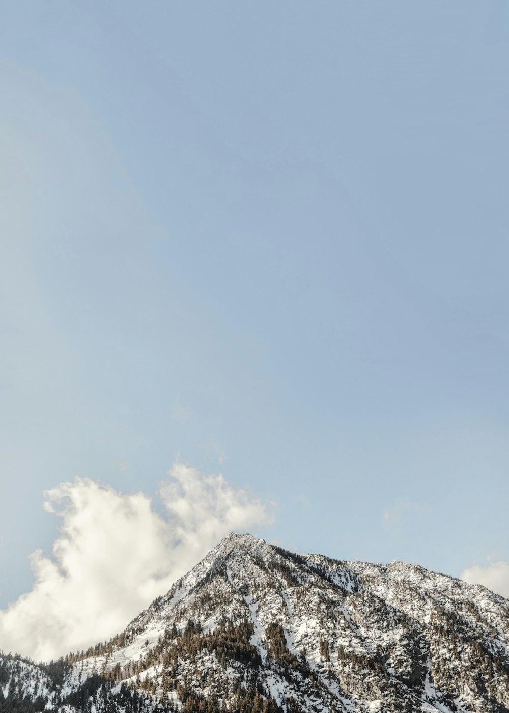 white clouds over snow covered mountain