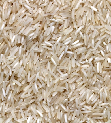 white rice grains on brown wooden table