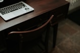macbook pro on brown wooden table