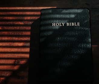 black and white book on brown wooden table