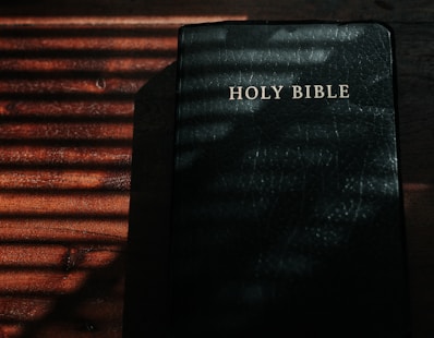 black and white book on brown wooden table