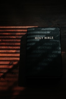 black and white book on brown wooden table