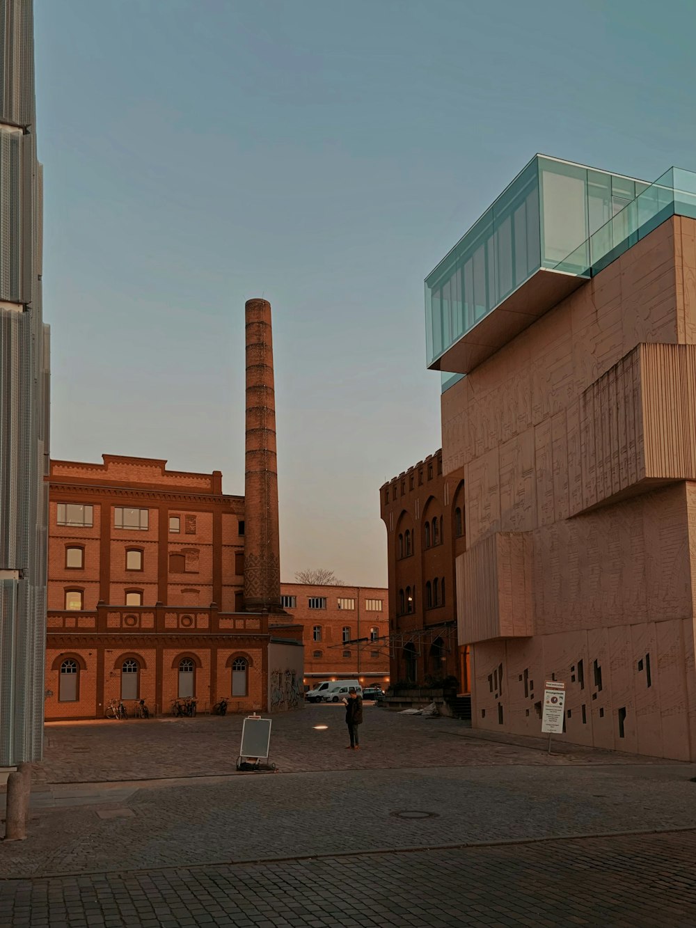 people walking on sidewalk near brown concrete building during daytime