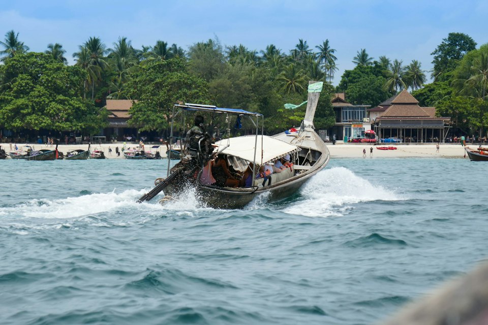 A speedboat crossing open water off the coast of Thailand
