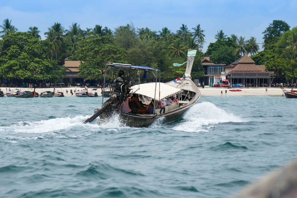 white and black boat on sea during daytime