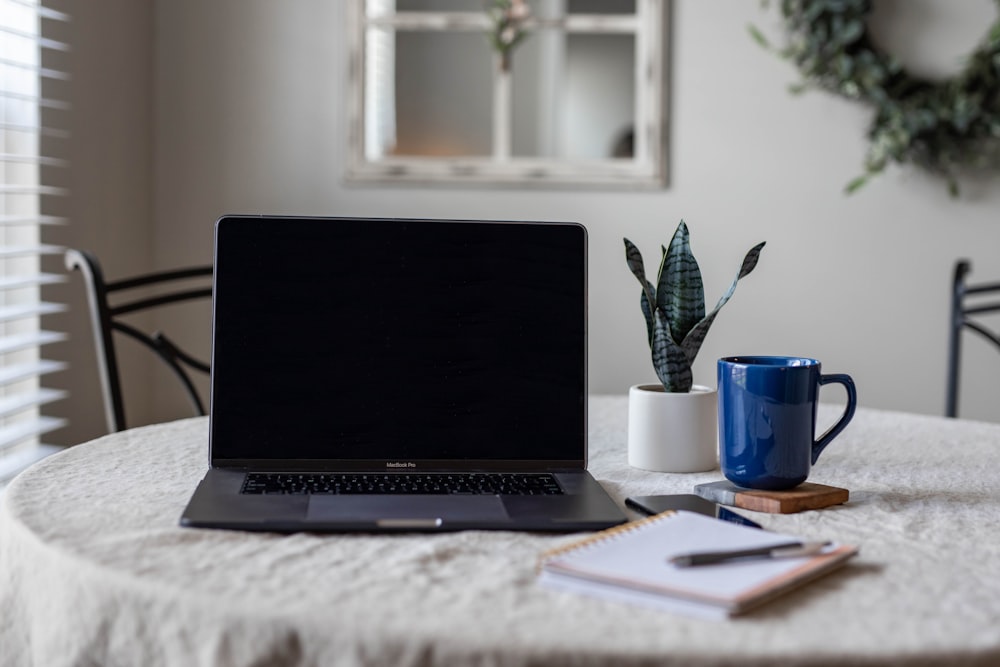 black laptop computer on white table