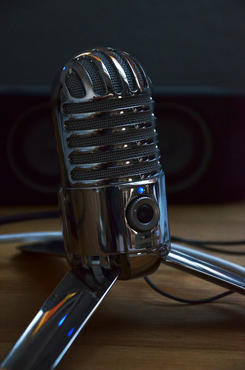 silver condenser microphone on brown wooden table