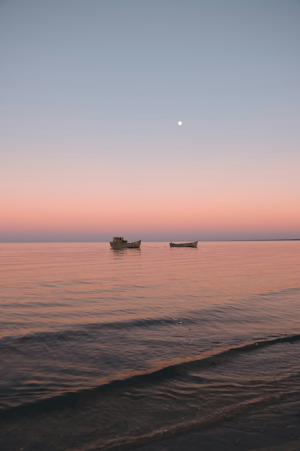 silhouette of a boat on the sea during sunset