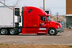 red and white truck on road during daytime